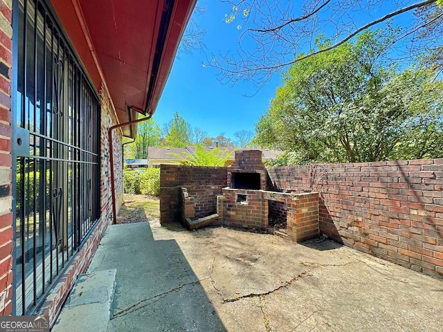 view of patio / terrace with an outdoor brick fireplace