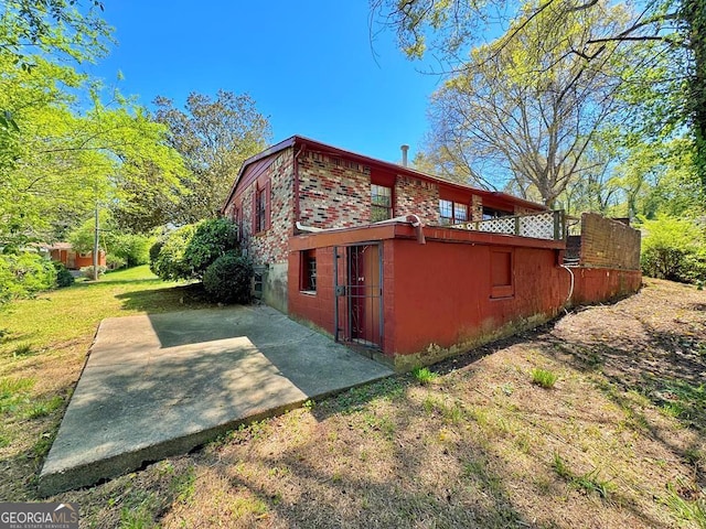 view of home's exterior featuring a yard and a patio