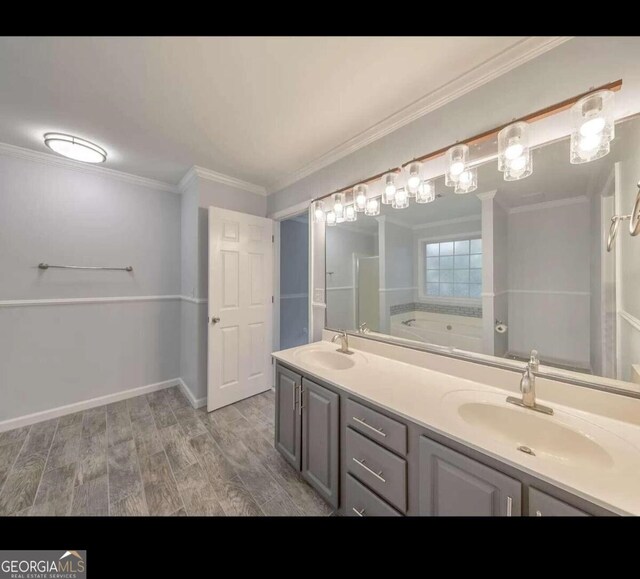 bathroom featuring crown molding, wood-type flooring, vanity, and a tub