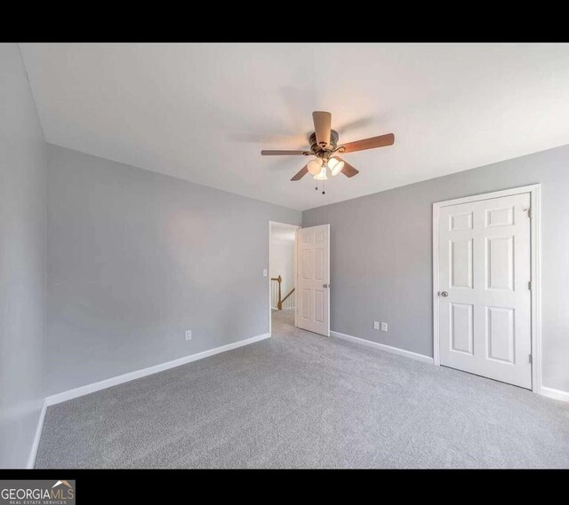 unfurnished bedroom with ceiling fan and carpet floors