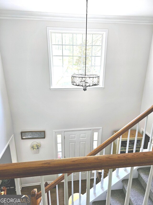 interior space featuring ornamental molding and an inviting chandelier