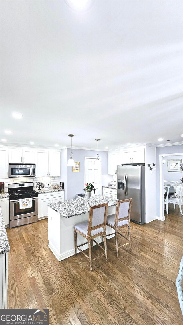 kitchen featuring stainless steel appliances, white cabinets, and dark hardwood / wood-style floors