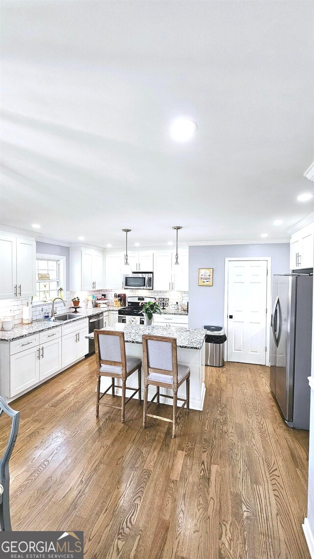 dining space with light hardwood / wood-style flooring and sink