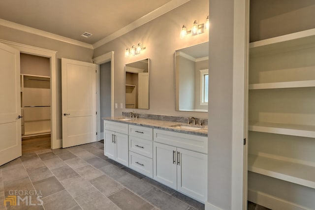 bathroom featuring crown molding, double sink vanity, and tile floors