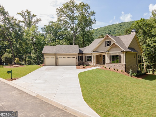 craftsman-style house featuring a garage and a front lawn