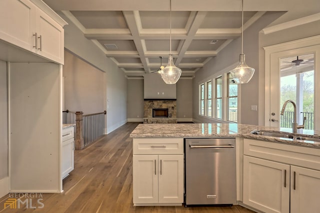 kitchen with coffered ceiling, a wealth of natural light, decorative light fixtures, and stainless steel dishwasher