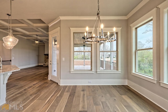 interior space featuring coffered ceiling, dark hardwood / wood-style flooring, beamed ceiling, ornamental molding, and ceiling fan with notable chandelier