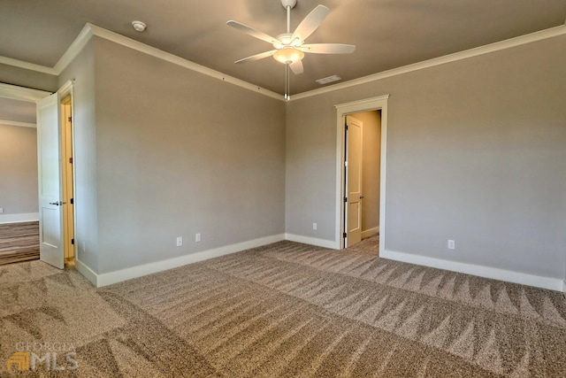 carpeted spare room with ornamental molding and ceiling fan