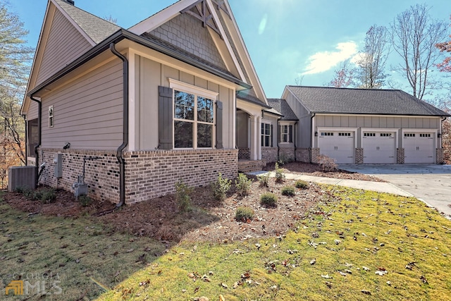 view of front of home with central air condition unit and a garage