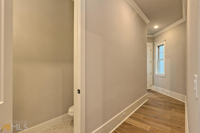 hall with ornamental molding and dark hardwood / wood-style floors