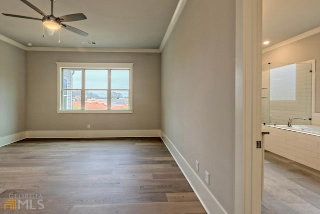 empty room with ceiling fan, crown molding, and light wood-type flooring