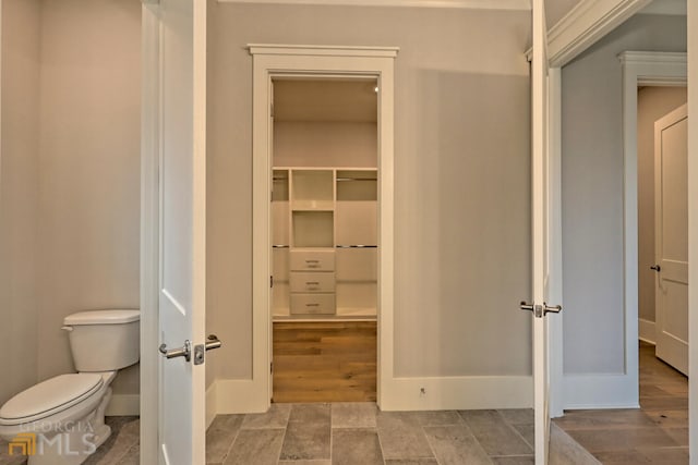 interior space with toilet and tile floors