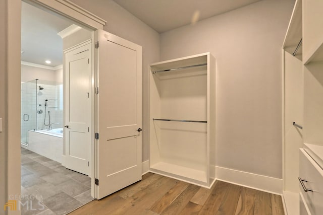 walk in closet with light tile floors