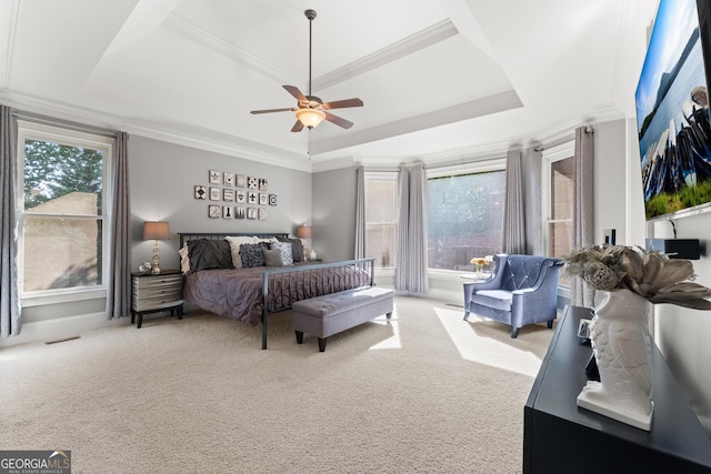 bedroom featuring light colored carpet, a raised ceiling, ceiling fan, and ornamental molding