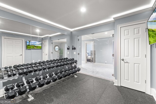 workout area featuring ornamental molding