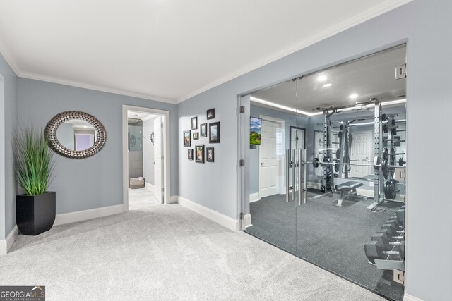 foyer with carpet flooring and crown molding