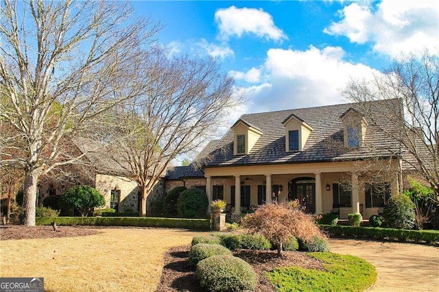 cape cod-style house with a front lawn