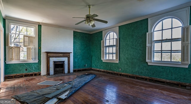 unfurnished living room with ornamental molding, wood-type flooring, and ceiling fan