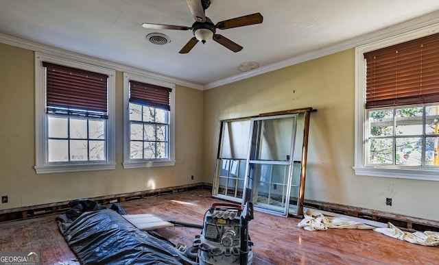 living room with hardwood / wood-style floors, ceiling fan, and crown molding