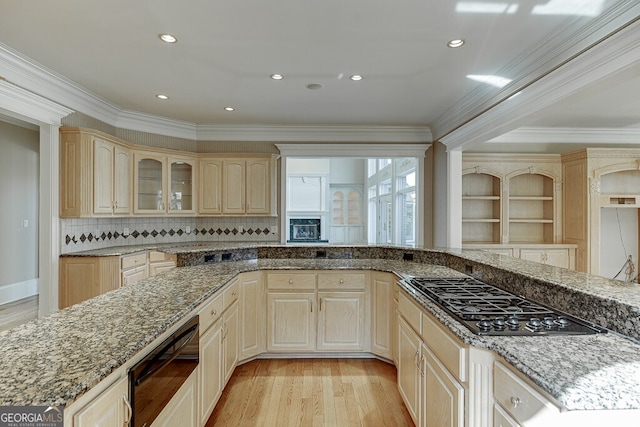 kitchen featuring crown molding, tasteful backsplash, light hardwood / wood-style floors, and light stone countertops