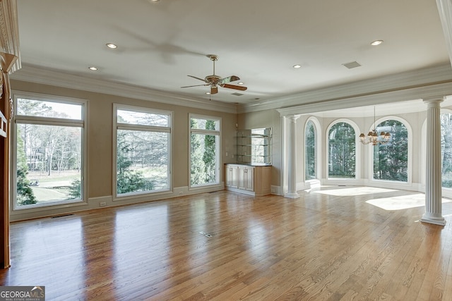 interior space featuring light hardwood / wood-style flooring, decorative columns, and ceiling fan with notable chandelier