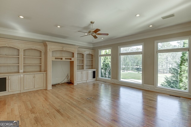 unfurnished living room featuring light hardwood / wood-style flooring, built in features, and plenty of natural light