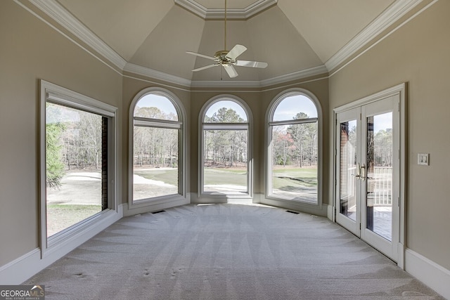 unfurnished sunroom featuring french doors, lofted ceiling, ceiling fan, and a wealth of natural light