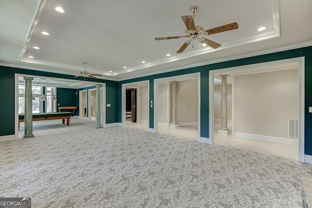 empty room featuring ceiling fan, a raised ceiling, light colored carpet, pool table, and ornate columns