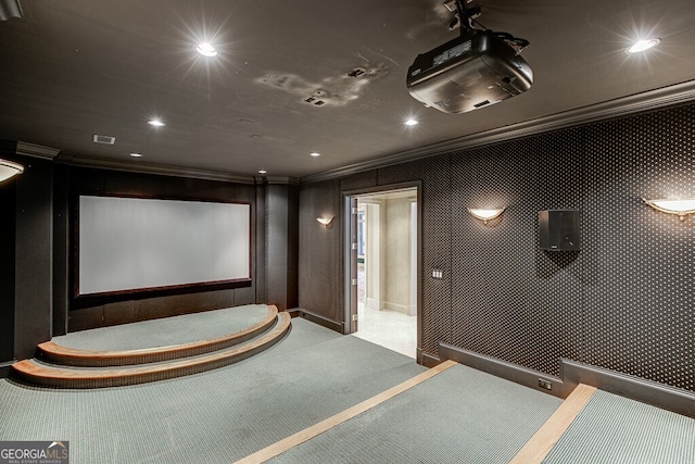 home theater room with carpet flooring and ornamental molding