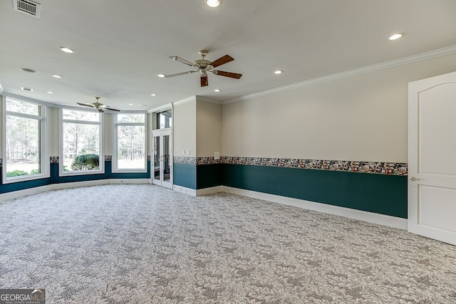 carpeted empty room with ceiling fan, french doors, and crown molding