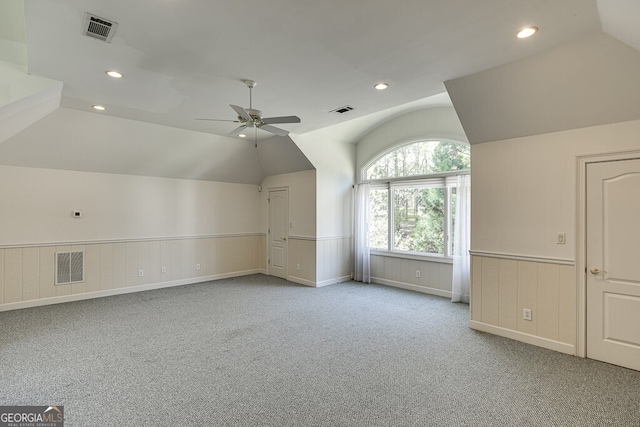 bonus room featuring light carpet, lofted ceiling, and ceiling fan