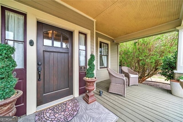 view of exterior entry with covered porch