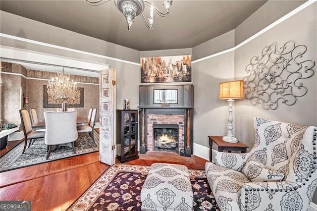 living area with a chandelier and wood-type flooring