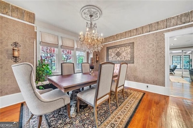 dining space with a notable chandelier and light hardwood / wood-style floors