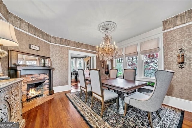 dining room with a healthy amount of sunlight, dark hardwood / wood-style flooring, and a chandelier