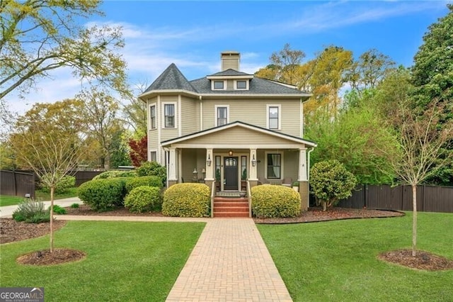 victorian house with a front yard and a porch