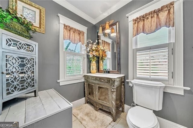 bathroom with ornamental molding, toilet, tile flooring, and vanity