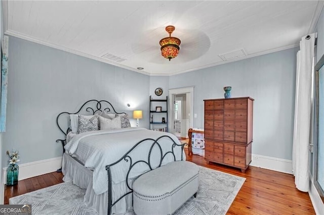 bedroom featuring ceiling fan, hardwood / wood-style flooring, and ornamental molding