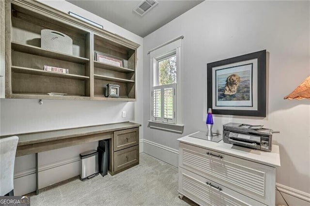 office featuring light colored carpet and built in desk