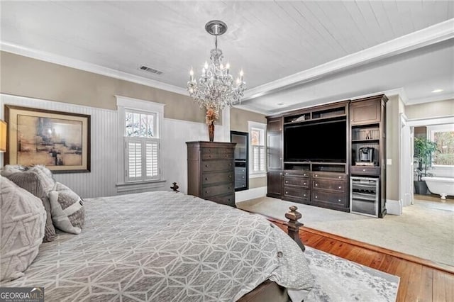 bedroom with ornamental molding, light colored carpet, a notable chandelier, and multiple windows