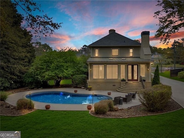 pool at dusk with a yard