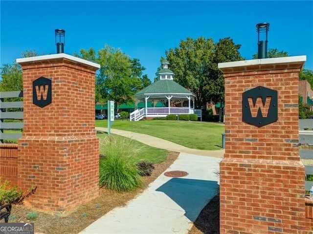 community / neighborhood sign with a lawn