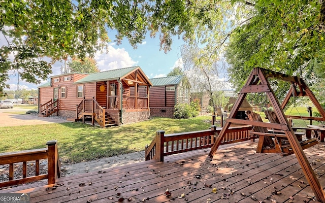 wooden terrace with a lawn and a playground