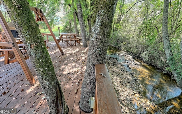 wooden deck featuring a water view