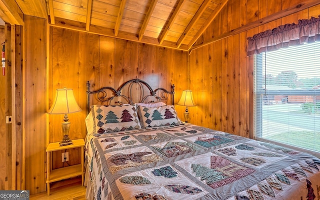 bedroom with wood walls, wood ceiling, vaulted ceiling with beams, and light hardwood / wood-style floors