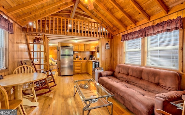 living room featuring wood walls, high vaulted ceiling, wooden ceiling, beamed ceiling, and light hardwood / wood-style flooring