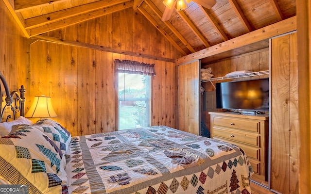 bedroom with wood walls, wood ceiling, a closet, and vaulted ceiling with beams