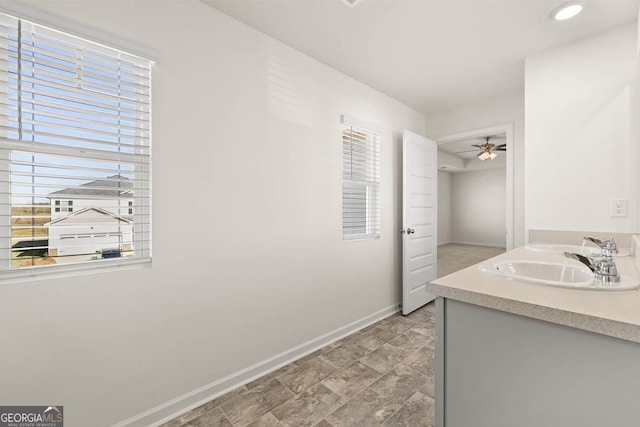 bathroom with ceiling fan, vanity, and plenty of natural light