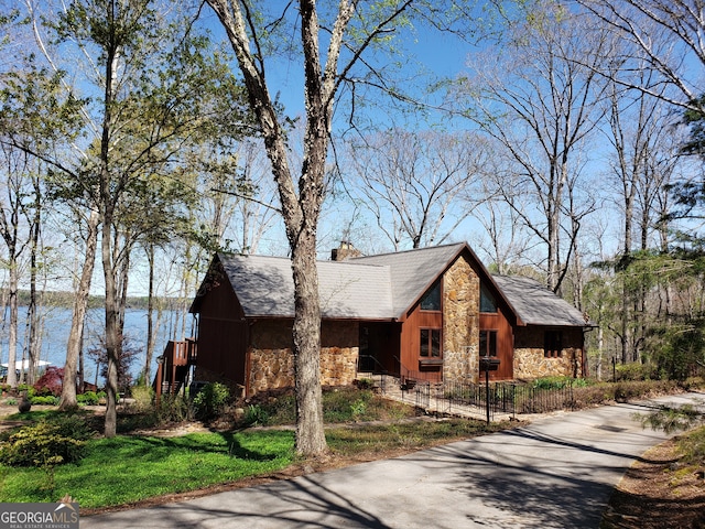 view of front of house with a water view