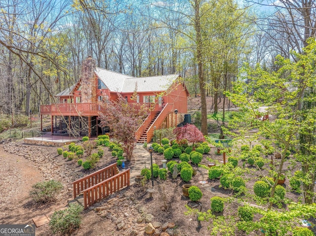 view of front facade with a deck and a patio